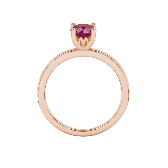 Round-cut raspberry red gemstone solitaire ring in a rose gold lotus basket setting