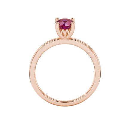 Round-cut raspberry red gemstone solitaire ring in a rose gold lotus basket setting