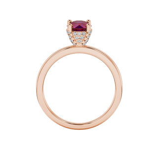 Round-cut raspberry red gemstone solitaire ring in a rose gold pavé basket diamond setting.