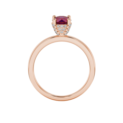 Round-cut raspberry red gemstone solitaire ring in a rose gold pavé basket diamond setting.