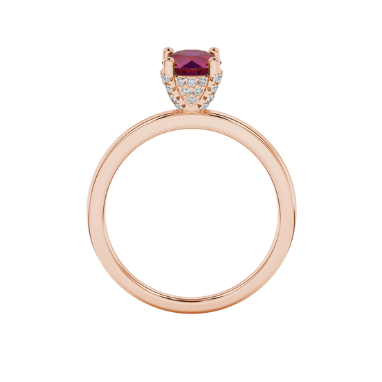 Round-cut raspberry red gemstone solitaire ring in a rose gold pavé basket diamond setting.