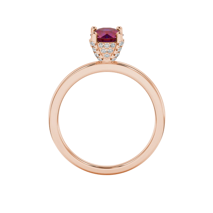 Round-cut raspberry red gemstone solitaire ring in a rose gold pavé basket diamond setting.