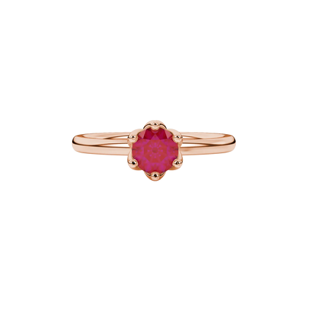 close-up shot of a round raspberry red gemstone ring with a rose gold scalloped six-prong design.