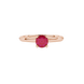 close-up shot of a round raspberry red gemstone ring with a rose gold surprise diamond setting design.