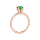 Side angle of a rose gold emerald green gemstone ring showcasing the surprise diamond setting.