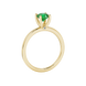 Side profile of a yellow gold emerald green gemstone ring with a surprise diamond design.