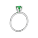 Side view of a white gold emerald green gemstone ring featuring a clean surprise diamond gallery.