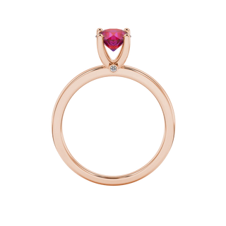 Round-cut raspberry red gemstone solitaire ring in a rose gold surprise diamond setting