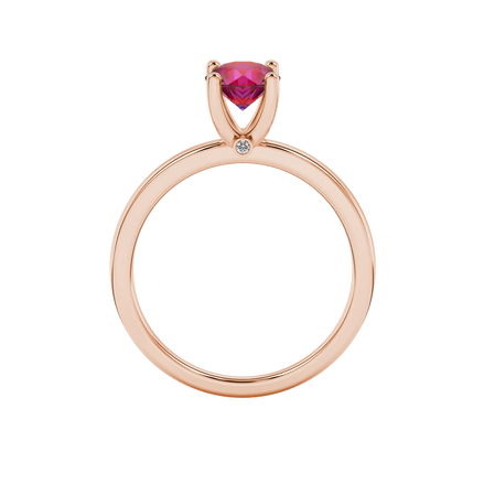 Round-cut raspberry red gemstone solitaire ring in a rose gold surprise diamond setting