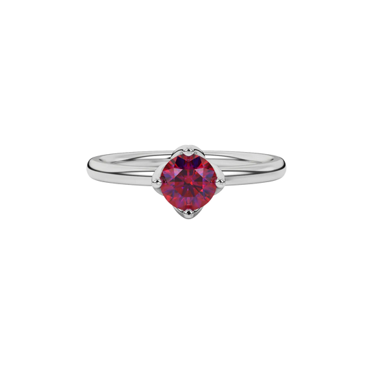 Close-up details of a round raspberry red gemstone secured in a white gold tulip basket setting.