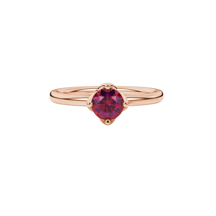 close-up shot of a round raspberry red gemstone ring with a rose gold tulip basket design.