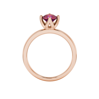 Round-cut raspberry red gemstone solitaire ring in a rose gold tulip basket setting