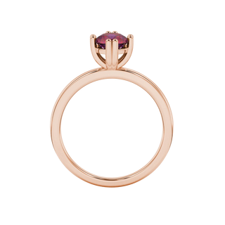 Round-cut raspberry red gemstone solitaire ring in a rose gold vintage basket setting.