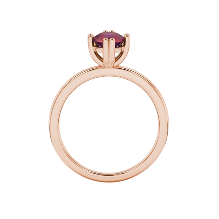 Round-cut raspberry red gemstone solitaire ring in a rose gold vintage basket setting.