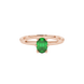 Close-up, oval cut emerald green gemstone ring, rose gold six prong setting.