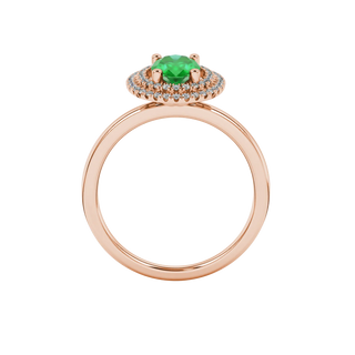 Oval cut emerald green gemstone ring, rose gold falling edge halo setting.
