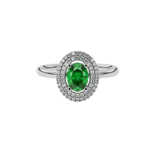 Close-up emerald green gemstone ring, white gold falling edge halo.