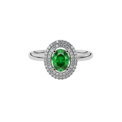 Close-up emerald green gemstone ring, white gold falling edge halo.