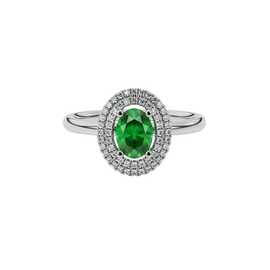 Close-up emerald green gemstone ring, white gold falling edge halo.