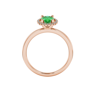 Oval cut emerald green gemstone ring, rose gold french pavé halo setting.