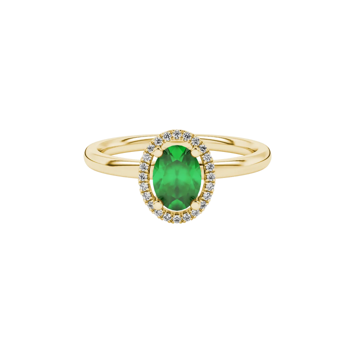 Close-up, oval cut emerald green gemstone, yellow gold french pavé halo ring.