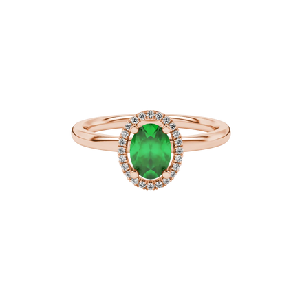 Close-up, oval cut emerald green gemstone ring, rose gold french pavé halo.