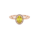 Close-up, oval cut canary yellow gemstone ring, rose gold french pavé halo.