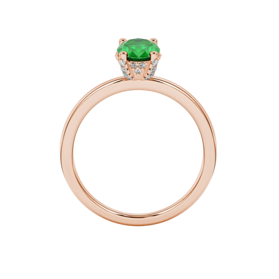Oval cut emerald green gemstone ring, rose gold pavé basket setting.