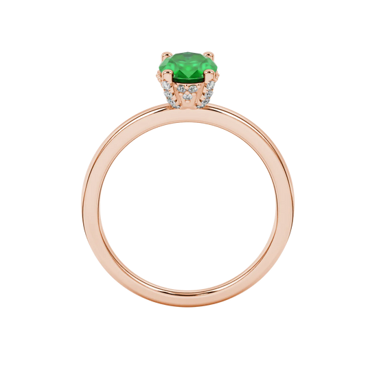 Oval cut emerald green gemstone ring, rose gold pavé basket setting.