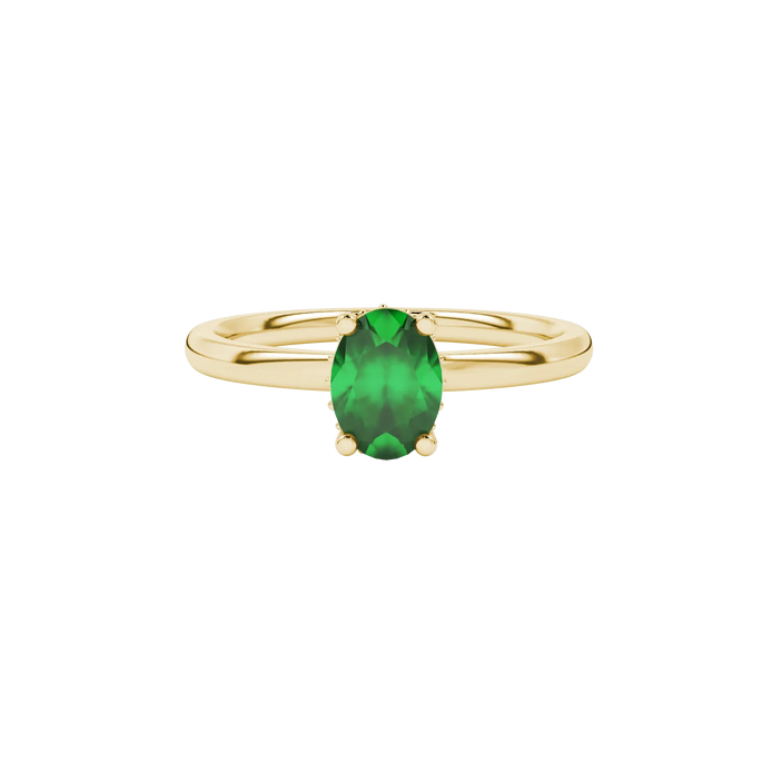 Close-up, oval cut emerald green gemstone, yellow gold pavé basket ring.