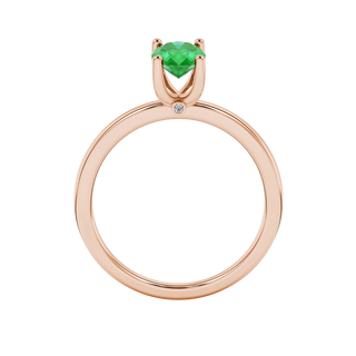 Oval cut emerald green gemstone ring, rose gold surprise diamond setting.