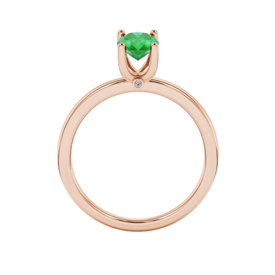 Oval cut emerald green gemstone ring, rose gold surprise diamond setting.