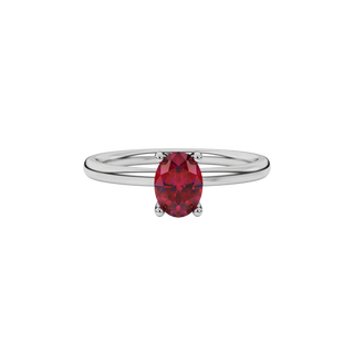 Close-up raspberry red gemstone ring, white gold surprise diamond setting.
