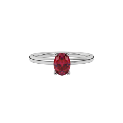 Close-up raspberry red gemstone ring, white gold surprise diamond setting.