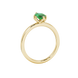 Side profile, yellow gold emerald green ring, scalloped six prong gallery.