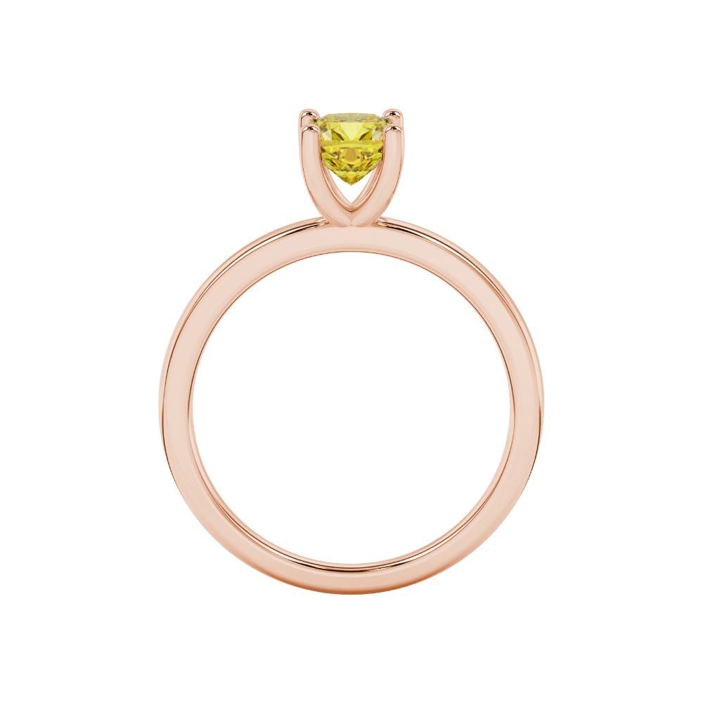 Yellow cushion cut gemstone solitaire ring in gold featuring a refined four-prong cathedral basket setting