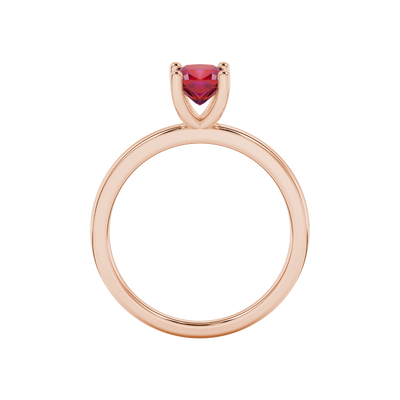 Red cushion cut gemstone solitaire ring in gold featuring a refined four-prong cathedral basket setting