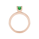 Green cushion cut gemstone solitaire ring in gold featuring a refined four-prong cathedral basket setting