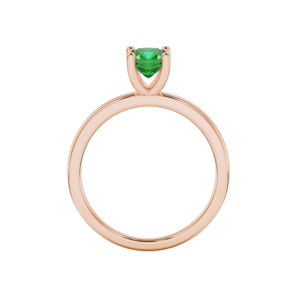 Green cushion cut gemstone solitaire ring in gold featuring a refined four-prong cathedral basket setting