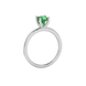 Green cushion cut gemstone solitaire ring in gold featuring a refined four-prong cathedral basket setting