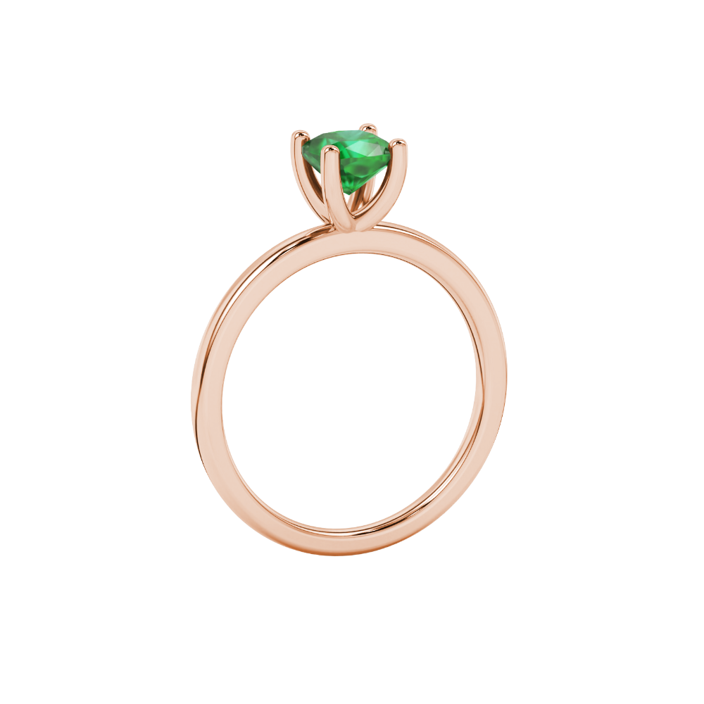 Green cushion cut gemstone solitaire ring in gold featuring a refined four-prong cathedral basket setting