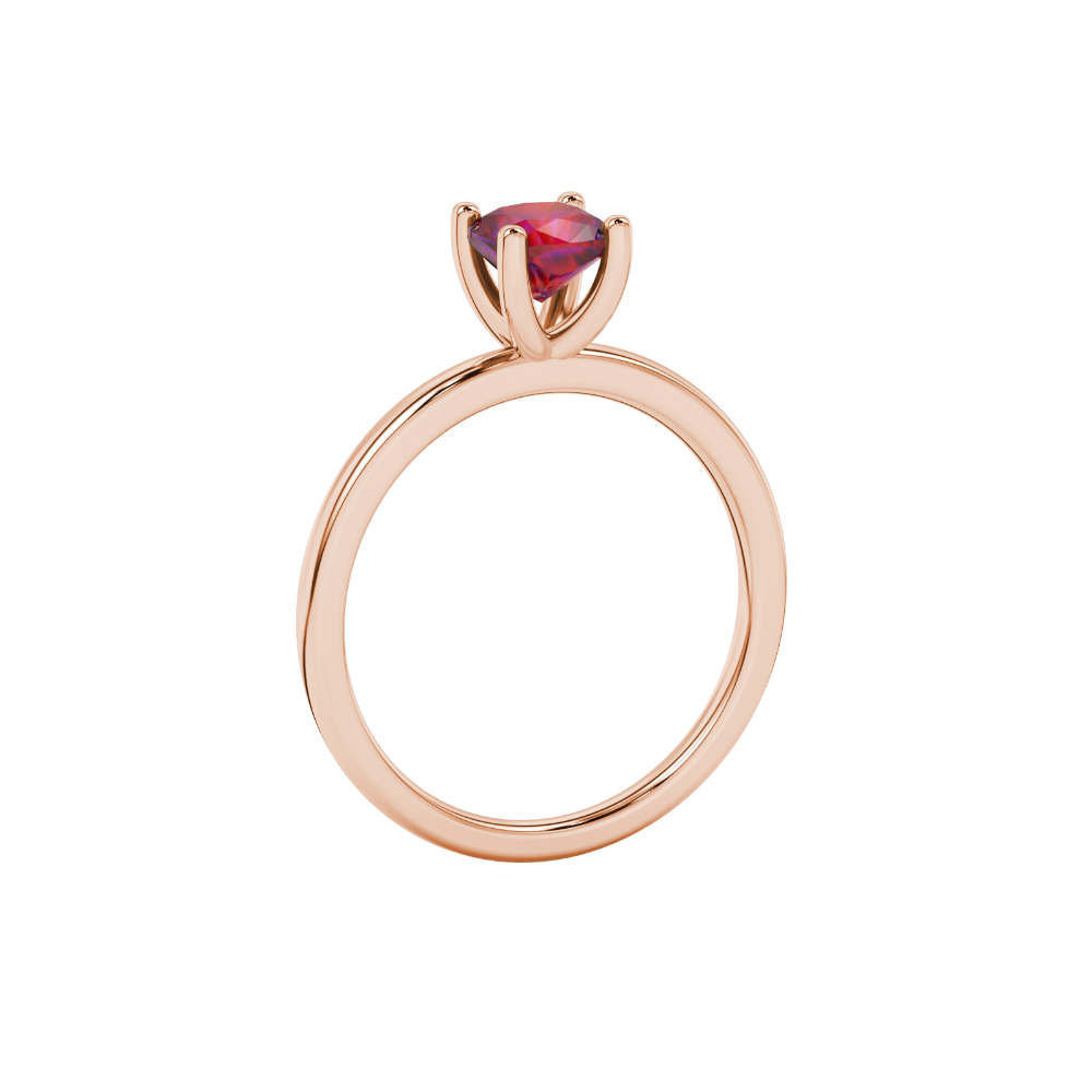 Red cushion cut gemstone solitaire ring in gold featuring a refined four-prong cathedral basket setting