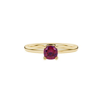 Red cushion cut gemstone solitaire ring in gold featuring a refined four-prong cathedral basket setting