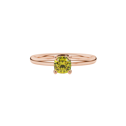 Yellow cushion cut gemstone solitaire ring in gold featuring a refined four-prong cathedral basket setting