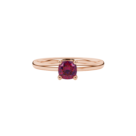 Red cushion cut gemstone solitaire ring in gold featuring a refined four-prong cathedral basket setting