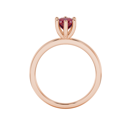 Red cushion cut gemstone solitaire ring in gold featuring a six-prong crown basket setting