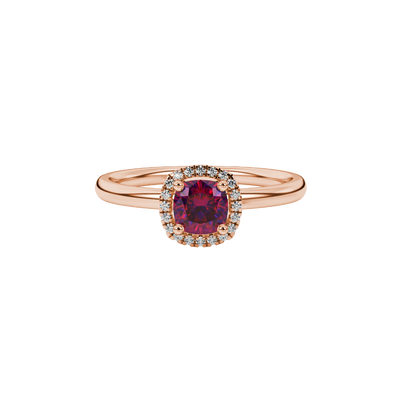 Red cushion cut gemstone halo ring with diamond accents in gold