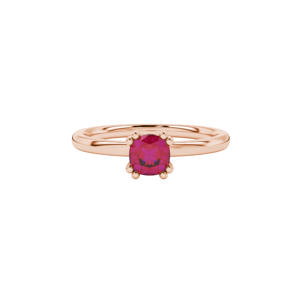 Red cushion cut solitaire gemstone ring in six-prong gold setting with slim stackable band