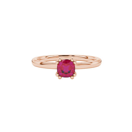 Red cushion cut solitaire gemstone ring in six-prong gold setting with slim stackable band