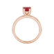 Red cushion cut solitaire gemstone ring in six-prong gold setting with slim stackable band